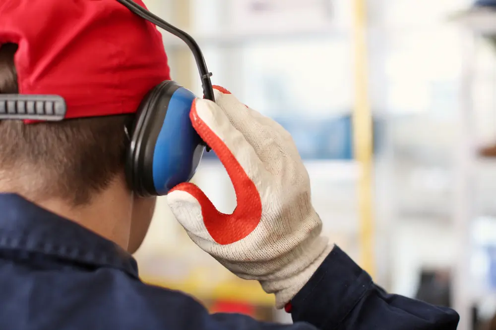 worker with ear muffs in factory